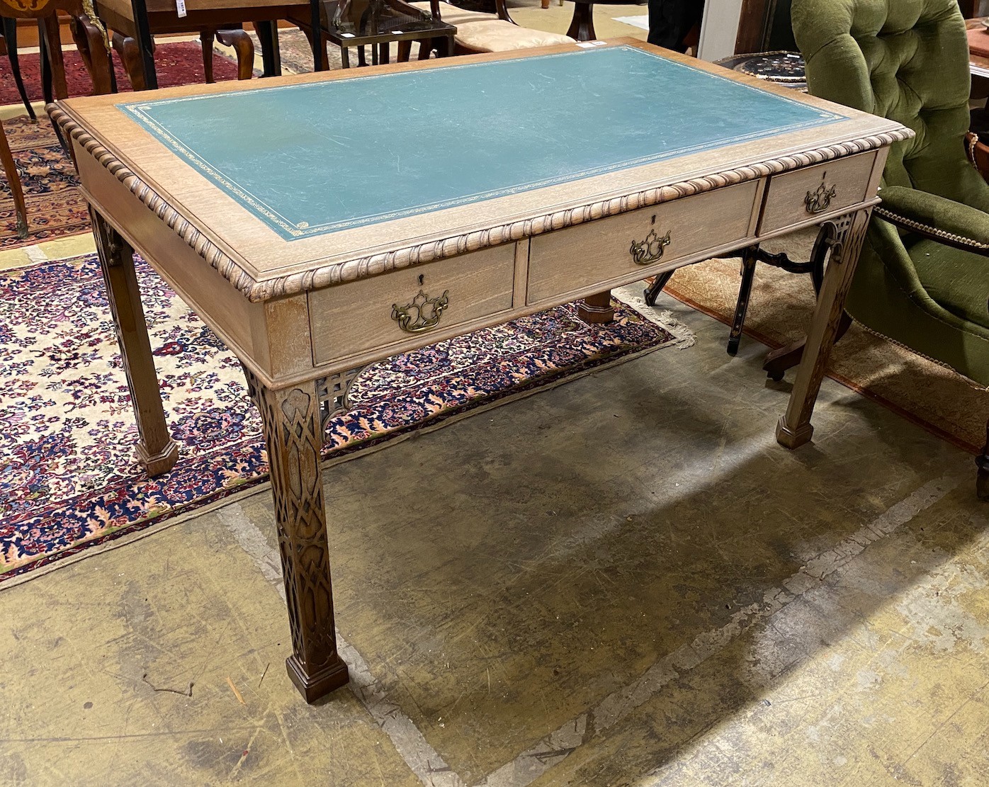 An early 20th century Chippendale revival mahogany partner's writing table, length 139cm, depth 83cm, height 78cm (one side severely sun-faded)